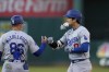 Los Angeles Dodgers' Shohei Ohtani, right, celebrates with first base coach Clayton McCullough after hitting a single against the Oakland Athletics during the fifth inning of a baseball game Saturday, Aug. 3, 2024, in Oakland, Calif. (AP Photo/Godofredo A. Vásquez)