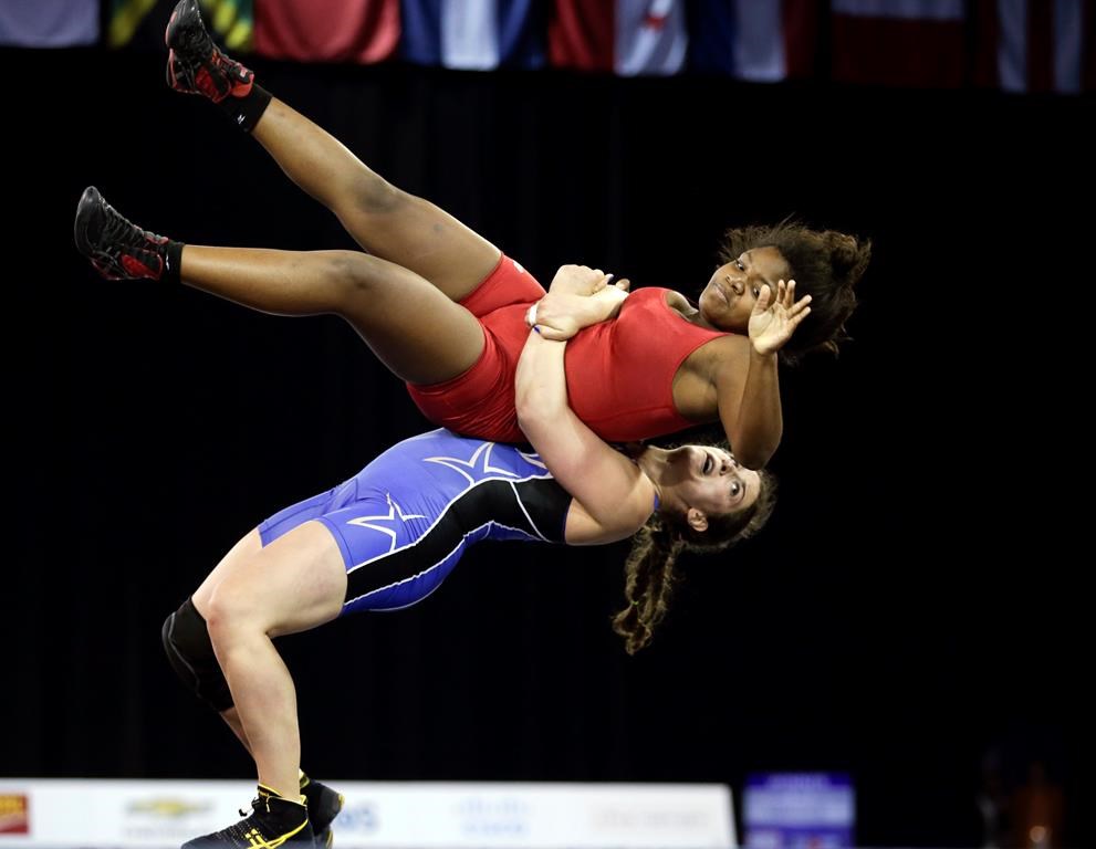 FILE- United States' Adeline Gray, below, takes down Puerto Rico's Ana Gonzalez during a women's freestyle 75 kg semifinal wrestling match in the Pan Am Games in Mississauga, Ontario, July 17, 2015. (AP Photo/Gregory Bull, File)