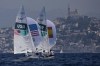 Lara Dallman-Weiss and Stuart McNay of the United States and Jordi Xammar Hernandez and Nora Brugman Cabot of Spain fly spinnakers during a 470 mixed dinghy class race the 2024 Summer Olympics, Friday, Aug. 2, 2024, in Marseille, France. (AP Photo/Carolyn Kaster)