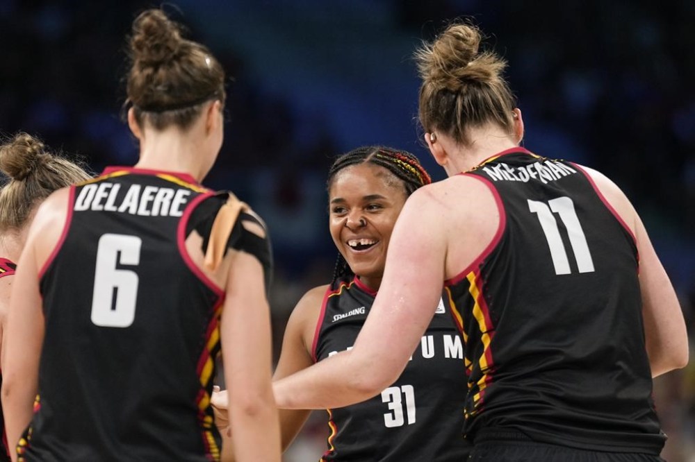 Maxuella Lisowa-Mbaka (31), of Belgium, celebrates with Antonia Delaere (6), and Emma Meesseman (11), after forcing a turn over in a women's basketball game against Japan at the 2024 Summer Olympics, Sunday, Aug. 4, 2024, in Villeneuve-d'Ascq, France. (AP Photo/Mark J. Terrill)