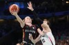 Julie Vanloo (35), of Belgium, shoots over Yuki Miyazawa (52), of Japan, in a women's basketball game at the 2024 Summer Olympics, Sunday, Aug. 4, 2024, in Villeneuve-d'Ascq, France. (AP Photo/Mark J. Terrill)