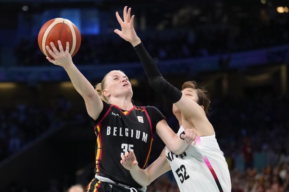 Julie Vanloo (35), of Belgium, shoots over Yuki Miyazawa (52), of Japan, in a women's basketball game at the 2024 Summer Olympics, Sunday, Aug. 4, 2024, in Villeneuve-d'Ascq, France. (AP Photo/Mark J. Terrill)