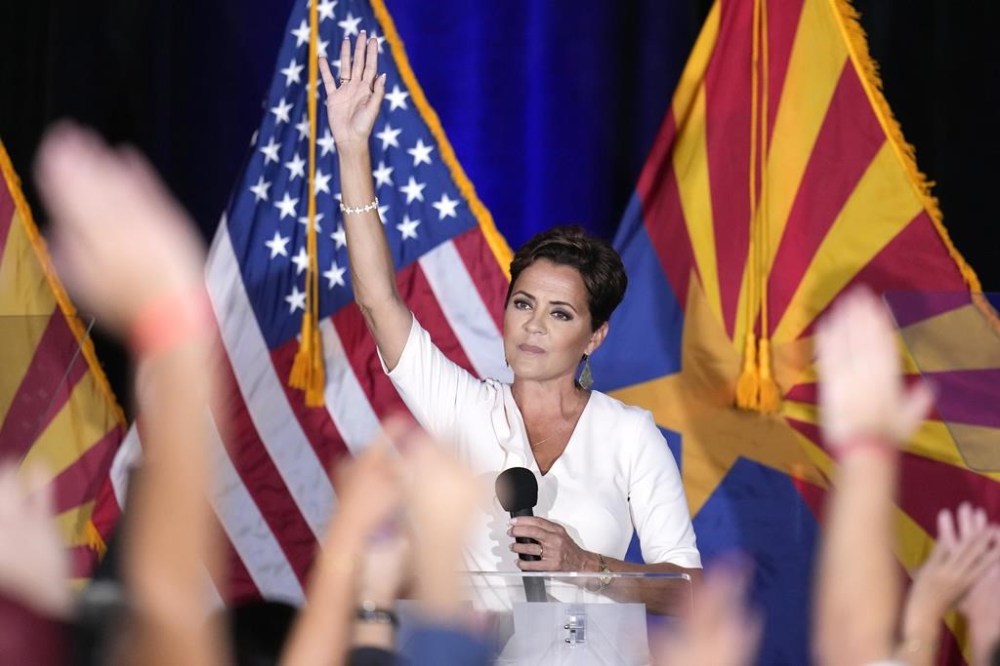 Republican Arizona Senate candidate Kari Lake waves to supporters after being declared the primary winner Tuesday, July 30, 2024, in Phoenix. (AP Photo/Ross D. Franklin)