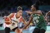 Kia Nurse (5), of Canada, drives around Promise Amukamara (10), of Nigeria, in a women's basketball game at the 2024 Summer Olympics, Sunday, Aug. 4, 2024, in Villeneuve-d'Ascq, France. THE CANADIAN PRESS/AP/Mark J. Terrill