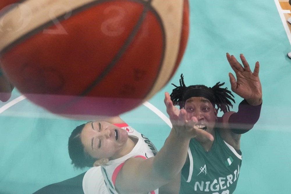 Ezinne Kalu (23), of Nigeria, shoots over Natalie Achonwa (11), of Canada, in a women's basketball game at the 2024 Summer Olympics, Sunday, Aug. 4, 2024, in Villeneuve-d'Ascq, France. (AP Photo/Mark J. Terrill, Pool)