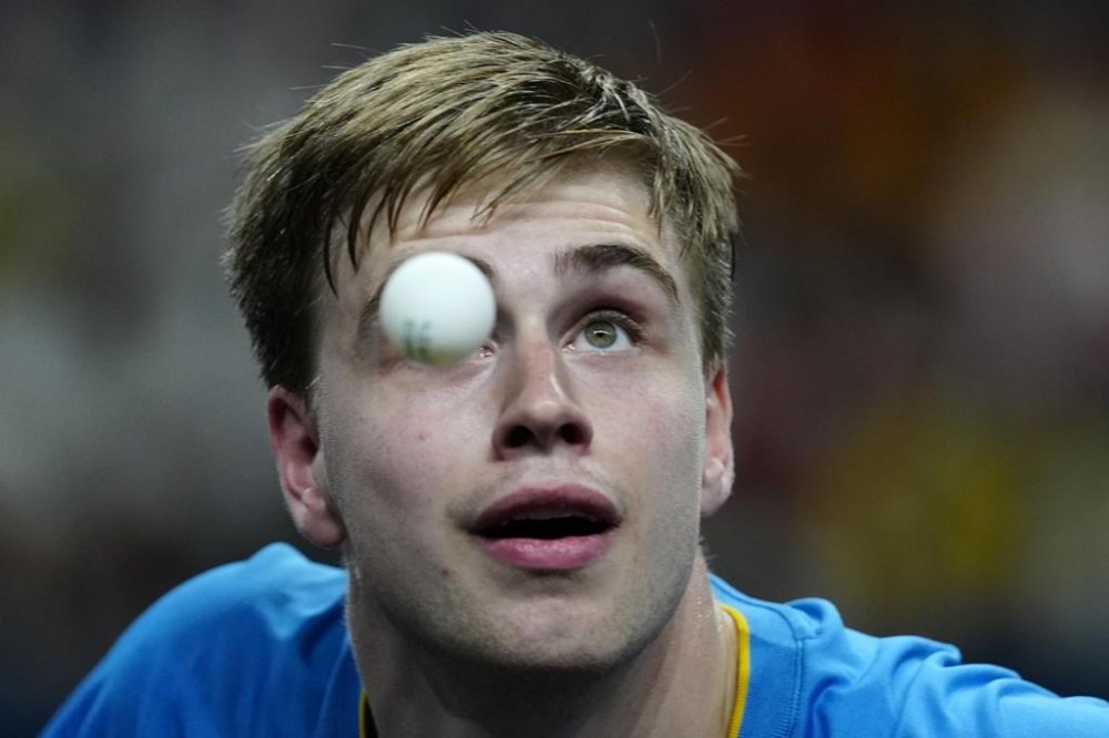 Sweden's Truls Moregard plays against China's Fan Zhendong during the men's singles gold medal table tennis match at the 2024 Summer Olympics, Sunday, Aug. 4, 2024, in Paris, France. (AP Photo/Petros Giannakouris)