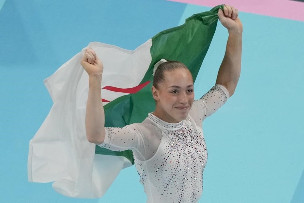 Kaylia Nemour, of Algeria, reacts after winning the gold medal during the women's artistic gymnastics individual uneven bars finals in Bercy Arena at the 2024 Summer Olympics, Sunday, Aug. 4, 2024, in Paris, France. (AP Photo/Morry Gash)