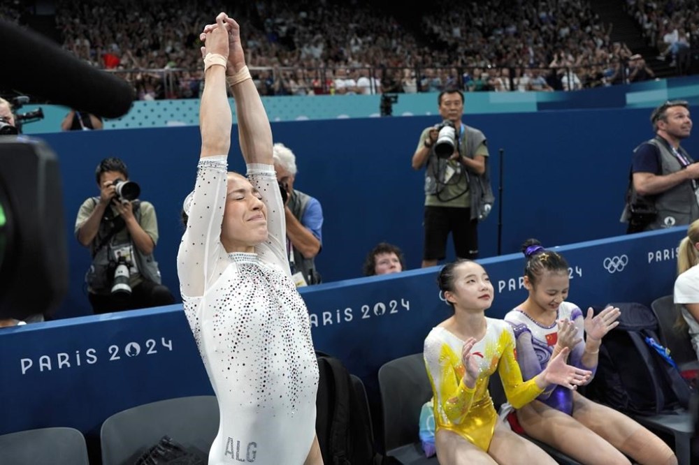 Kaylia Nemour, of Algeria, reacts after receiving her scores during the women's artistic gymnastics individual uneven bars finals at Bercy Arena at the 2024 Summer Olympics, Sunday, Aug. 4, 2024, in Paris, France. (AP Photo/Charlie Riedel)