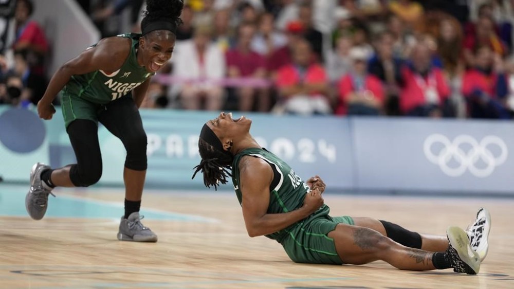 Ezinne Kalu (23), and Promise Amukamara (10), of Nigeria, celebrate in a women's basketball game against Canada at the 2024 Summer Olympics, Sunday, Aug. 4, 2024, in Villeneuve-d'Ascq, France. (AP Photo/Mark J. Terrill)