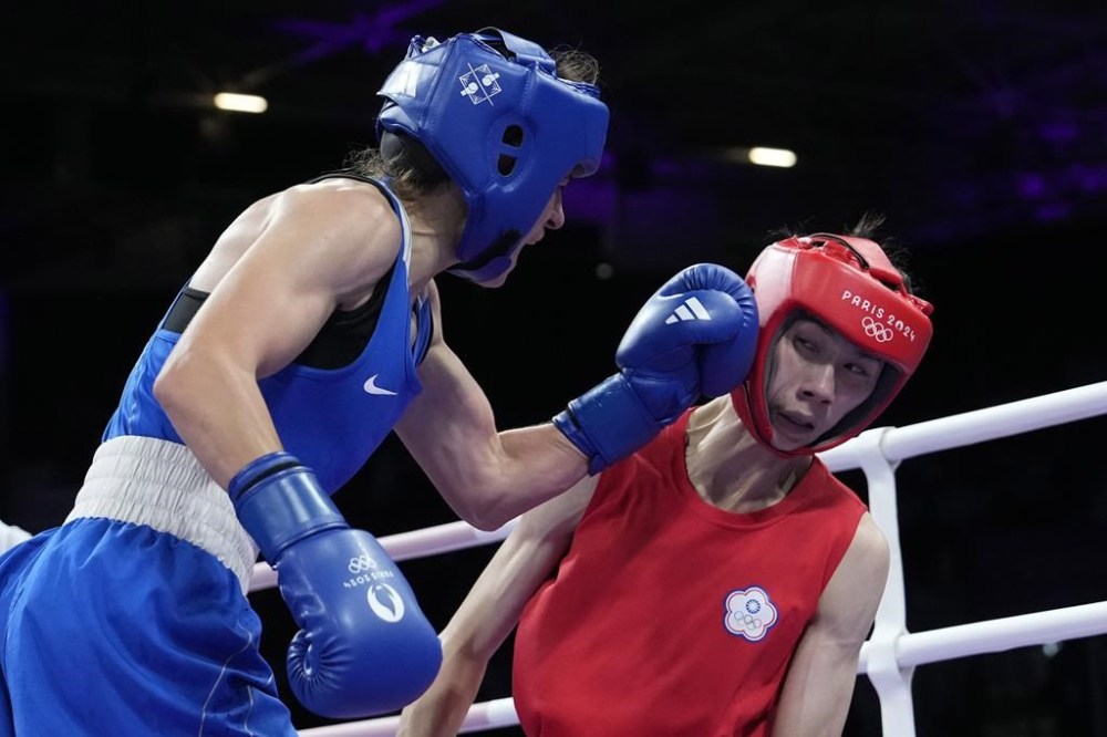 Bulgaria's Svetlana Staneva hits Taiwan's Lin Yu-ting in their women's 57 kg quarterfinal boxing match at the 2024 Summer Olympics, Sunday, Aug. 4, 2024, in Paris, France. (AP Photo/Ariana Cubillos)