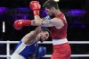 France's Sofiane Oumiha, left, punches Canada's Wyatt Sanford in their men's 63.5 kg semifinal boxing match at the 2024 Summer Olympics, Sunday, Aug. 4, 2024, in Paris, France. Sanford ended one streak and continued another on Day 9 of the Paris Olympics. THE CANADIAN PRESS/AP Photo/Ariana Cubillos