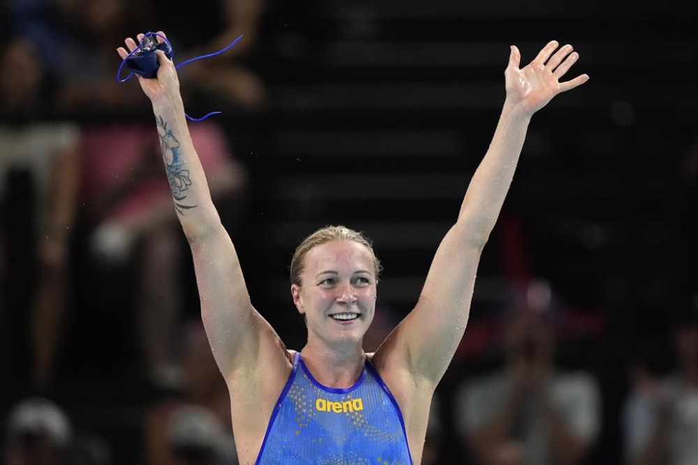 Sweden's Sarah Sjoestroem celebrates after winning the gold medal in the women's 50-meter freestyle final at the Summer Olympics in Nanterre, France, Sunday, Aug. 4, 2024. (AP Photo/Brynn Anderson)