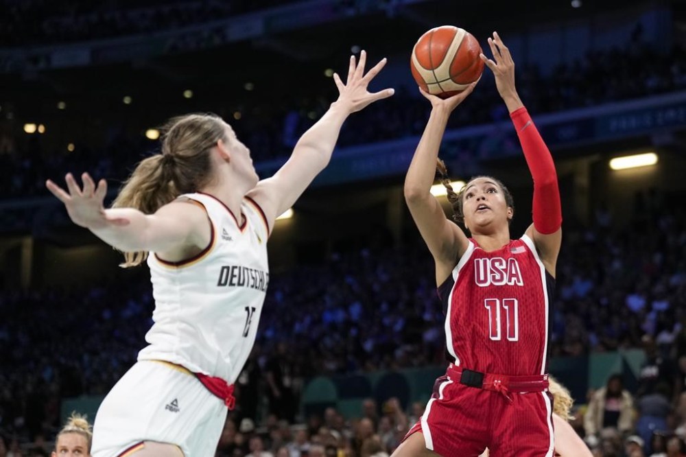 Napheesa Collier (11), of the United States, shoots over Luisa Geiselsoder (15), of Germany, in a women's basketball game at the 2024 Summer Olympics, Sunday, Aug. 4, 2024, in Villeneuve-d'Ascq, France. (AP Photo/Mark J. Terrill)