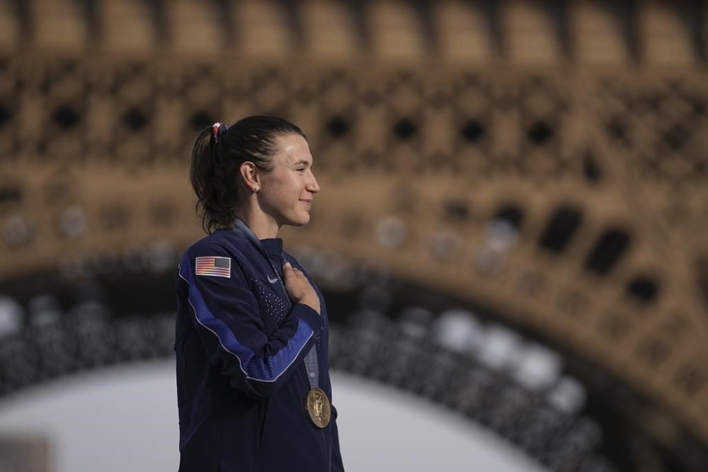 Kristen Faulkner, of the United States, winner of the gold medal of the women's road cycling event, attends the podium ceremony, at the 2024 Summer Olympics, Sunday, Aug. 4, 2024, in Paris, France. (AP Photo/Thibault Camus)