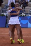 Sara Errani and Jasmine Paolini of Italy hug after they defeat Mirra Andreeva and Diana Shnaider of Individual Neutral Athlete in the women's doubles gold medal tennis match at the Roland Garros stadium, at the 2024 Summer Olympics, Sunday, Aug. 4, 2024, in Paris, France. (AP Photo/Andy Wong)