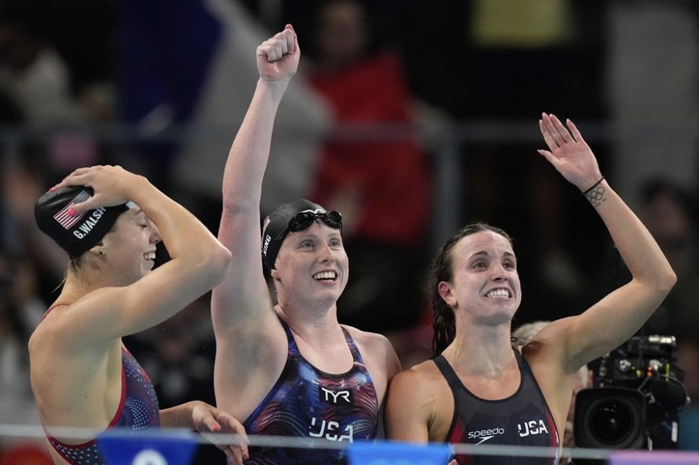 United States' Gretchen Walsh, left, Lilly King and Regan Smith celebrate winning the gold medal in the women's 4x100-meter medley relay final at the Summer Olympics in Nanterre, France, Sunday, Aug. 4, 2024. (AP Photo/Brynn Anderson)
