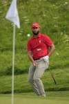 Jon Rahm, of Spain, chips onto the 14th green during the final round of the men's golf at the 2024 Summer Olympics, Sunday, Aug. 4, 2024, at Le Golf National in Saint-Quentin-en-Yvelines, France. (AP Photo/Matt York)