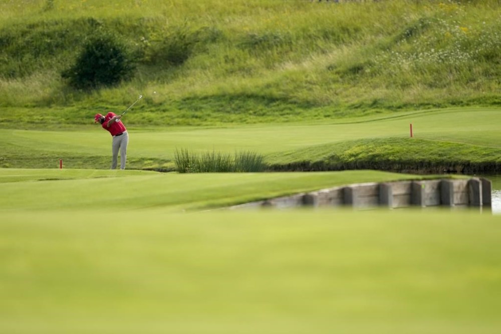 Jon Rahm, of Spain, plays a shot from the 18th fairway during the final round of the men's golf at the 2024 Summer Olympics, Sunday, Aug. 4, 2024, at Le Golf National in Saint-Quentin-en-Yvelines, France. (AP Photo/Matt York)