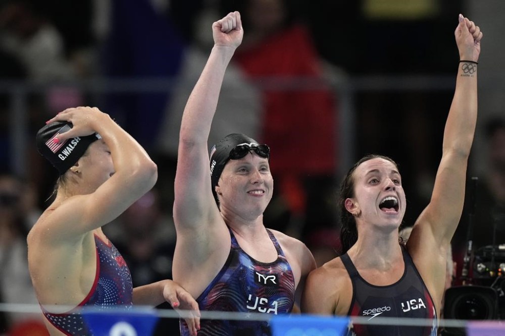 United States' Gretchen Walsh, from left, Lilly King and Regan Smith celebrate winning the gold medal in the women's 4x100-meter medley relay final at the Summer Olympics in Nanterre, France, Sunday, Aug. 4, 2024.(AP Photo/Brynn Anderson)