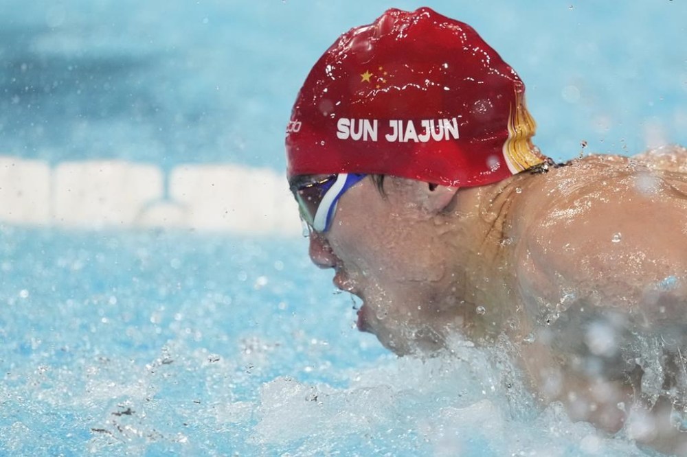 China's Jiajun Sun competes in a men's 100-meter butterfly heat at the Summer Olympics in Nanterre, France, Friday, Aug. 2, 2024. (AP Photo/Ashley Landis)