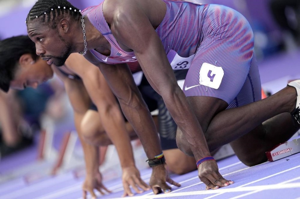 Noah Lyles, of the United States, prepares to start in the men's 100-meters semifinal at the 2024 Summer Olympics, Sunday, Aug. 4, 2024, in Saint-Denis, France. (AP Photo/Bernat Armangue)