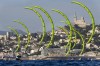 Switzerland's Elena Lengwiler leads the pack, with Marseille's Notre Dame de la Garde Basilica in the background, during a women's kite race, Sunday, Aug. 4, 2024, at the 2024 Summer Olympics in Marseille, France. (AP Photo/Jacquelyn Martin)