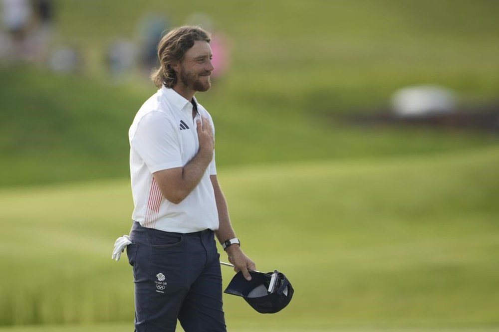 Tommy Fleetwood, of Britain, reacts t the crowd after winning the silver medal during the final round of the men's golf at the 2024 Summer Olympics, Sunday, Aug. 4, 2024, at Le Golf National in Saint-Quentin-en-Yvelines, France. Scottie Scheffler, of the United States, wins the gold medal with Tommy Fleetwood, of Britain, silver and Hideki Matsuyama, of Japan, the bronze. (AP Photo/Matt York)