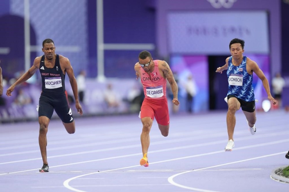 Sprinter Andre De Grasse, centre, competes in the men’s 100m semifinals at the 2024 Summer Olympics, Sunday, Aug. 4, 2024, in Saint-Denis, France. The six-time Olympic medallist from Markham, Ont., finished fifth in the third semifinal heat of the men's 100 metres. It's the first time De Grasse failed to qualify for an Olympic final, with it being his third appearance at the Games. THE CANADIAN PRESS/Nathan Denette