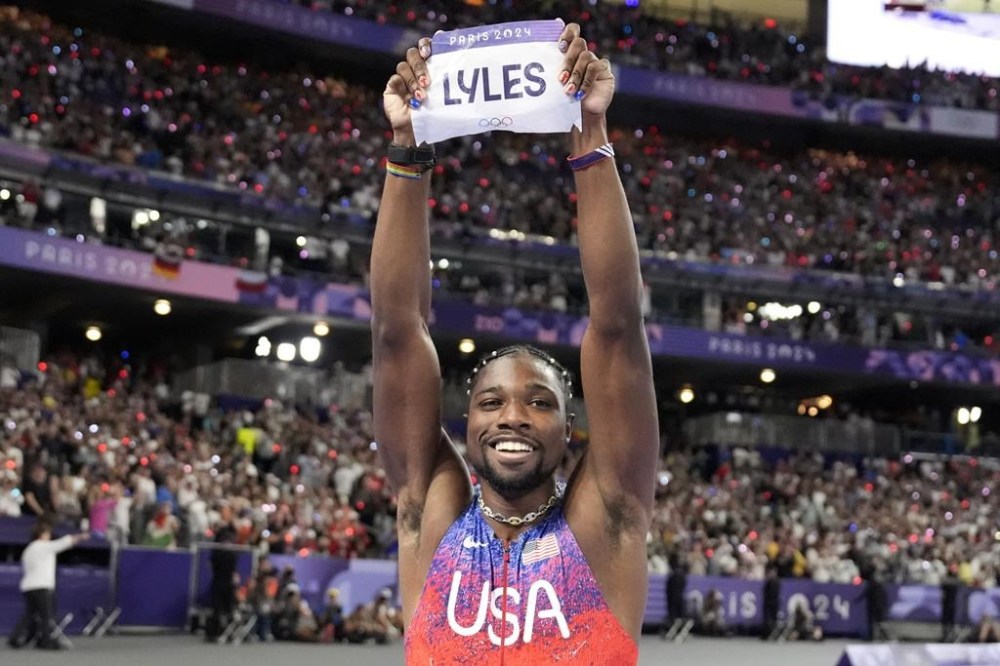 Noah Lyles, of the United States, celebrates after winning the men's 100-meters final at the 2024 Summer Olympics, Sunday, Aug. 4, 2024, in Saint-Denis, France. (AP Photo/Matthias Schrader)