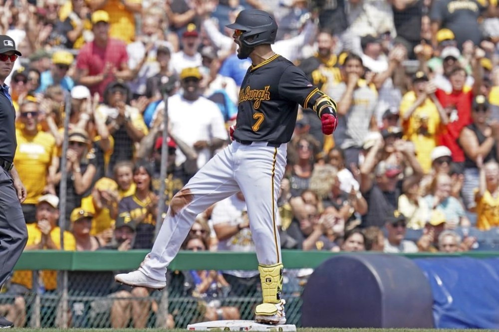 Pittsburgh Pirates' Isiah Kiner-Falefa reacts after hitting an RBI triple during the second inning of a baseball game against the Arizona Diamondbacks, Sunday, Aug. 4, 2024, in Pittsburgh. (AP Photo/Matt Freed)