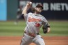 Baltimore Orioles starting pitcher Corbin Burnes delivers against the Cleveland Guardians during the first inning of a baseball game in Cleveland, Sunday, Aug. 4, 2024. (AP Photo/Phil Long)