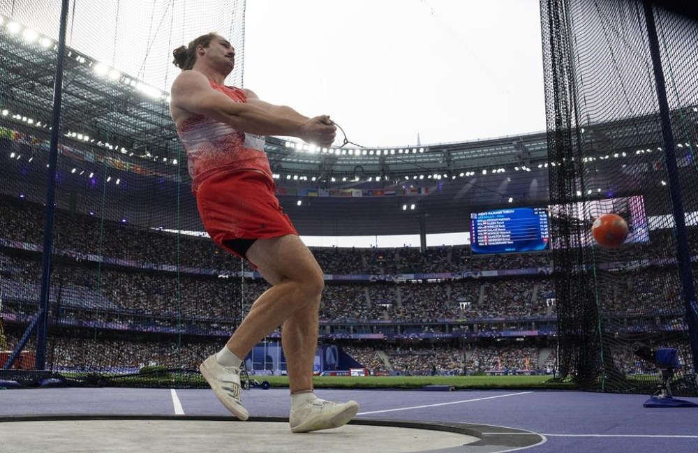 Ethan Katzberg, from Nanaimo, B.C. makes his first attempt during hammer competition at the Summer Olympics, Sunday, August 4, 2024 in Paris. Katzberg won gold in the competition with a distance of 84.12m. THE CANADIAN PRESS/Adrian Wyld