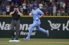 Texas Rangers' Corey Seager, right, runs out his home run past second base umpire John Libka, left, during the first inning of a baseball game against the Boston Red Sox in Arlington, Texas, Sunday, Aug. 4, 2024. (AP Photo/LM Otero)