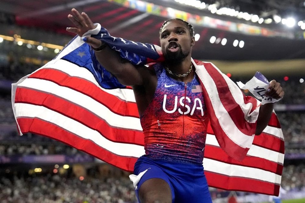Noah Lyles, of the United States, celebrates after winning the men's 100-meters final at the 2024 Summer Olympics, Sunday, Aug. 4, 2024, in Saint-Denis, France. (AP Photo/Matthias Schrader)
