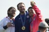 Bronze medalist Hideki Matsuyama, of Japan, right take a smart phone picture on the podium of gold medalist Scottie Scheffler, of the United States, centre, and Tommy Fleetwood, of Britain, silver medal, as they pose for the media following the medal ceremony for men's golf at the 2024 Summer Olympics, Sunday, Aug. 4, 2024, at Le Golf National in Saint-Quentin-en-Yvelines, France. (AP Photo/Matt York)
