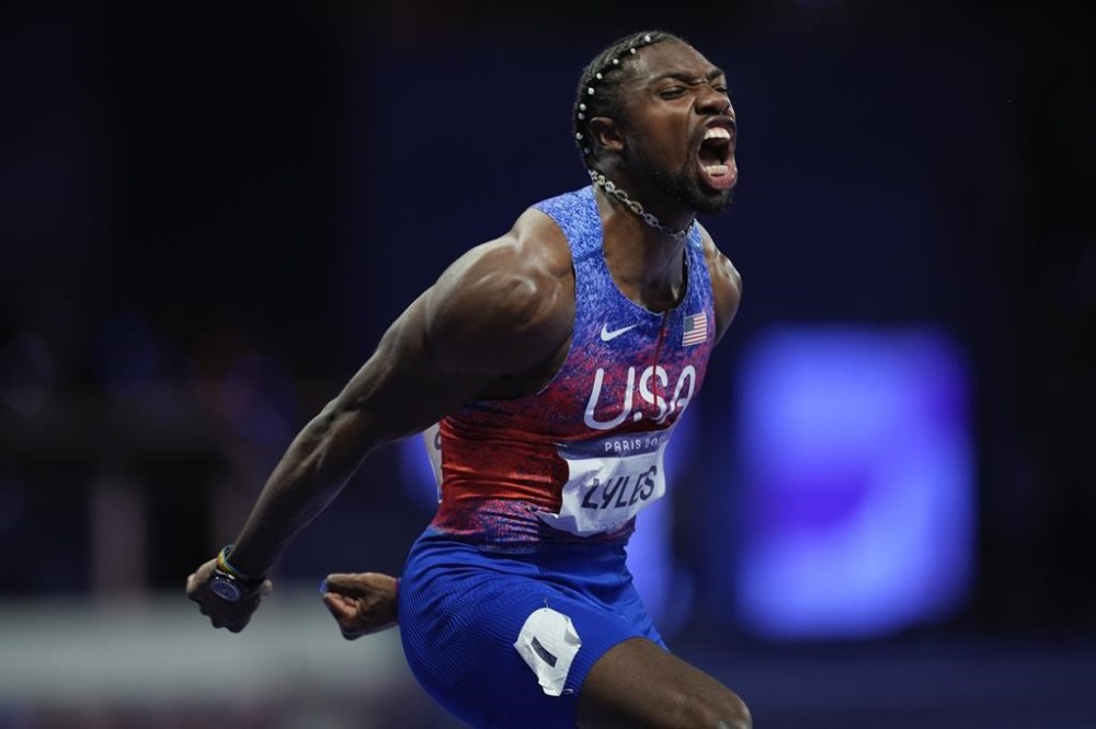Noah Lyles of the United States shouts as he arrives in the stadium for the men's 100-meter final at the 2024 Summer Olympics, Sunday, Aug. 4, 2024, in Saint-Denis, France. (AP Photo/Rebecca Blackwell)