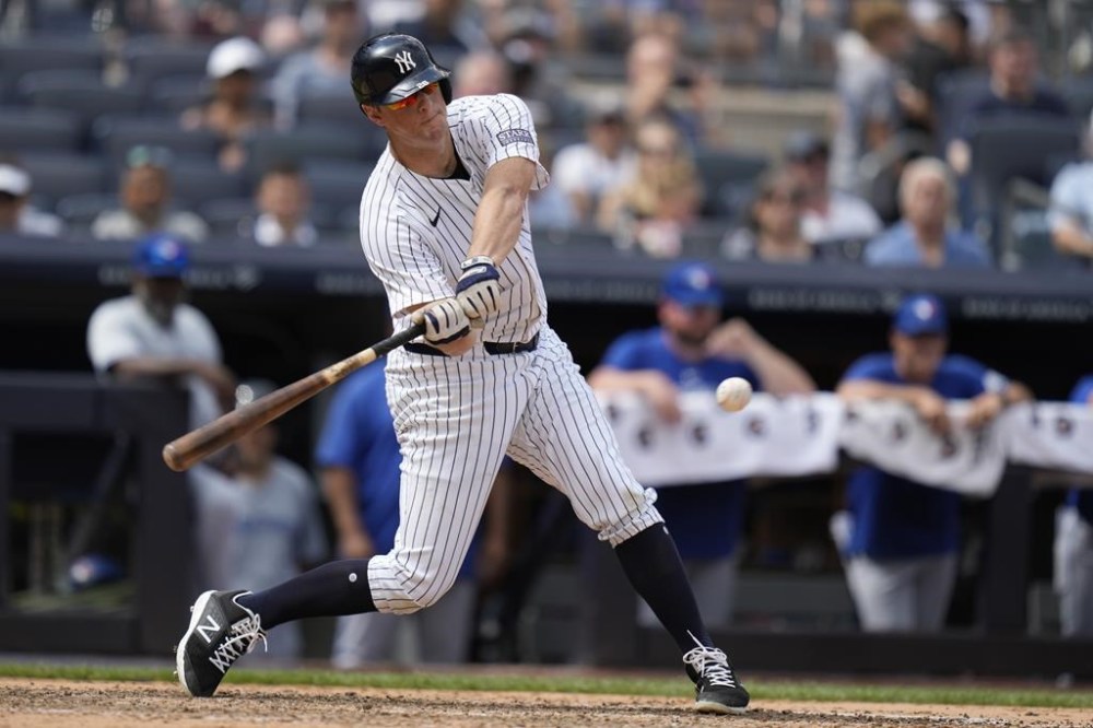 New York Yankees' DJ LeMahieu hits a sacrifice fly during the sixth inning of a baseball game against the Toronto Blue Jays at Yankee Stadium, Sunday, Aug. 4, 2024, in New York. (AP Photo/Seth Wenig)