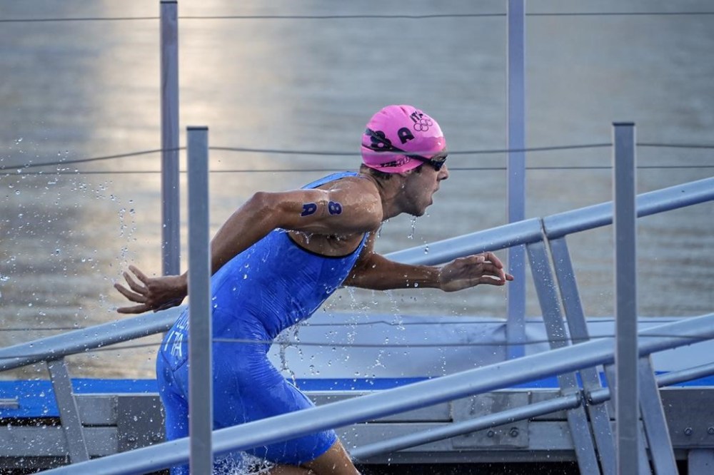Italy's Gianluca Pozzatti exits the water at the end of the swim leg of mixed relay triathlon at the 2024 Summer Olympics, Monday, Aug. 5, 2024, in Paris, France. (AP Photo/David Goldman)