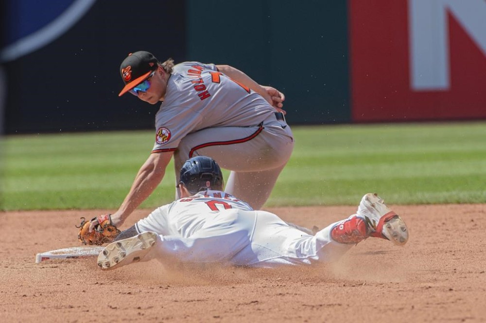Baltimore Orioles' Jackson Holliday, top, tags out Cleveland Guardians' Andres Gimenez, bottom, at second base during the fifth inning of a baseball game in Cleveland, Sunday, Aug. 4, 2024. (AP Photo/Phil Long)
