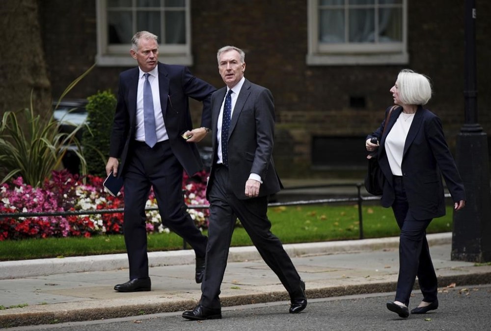 Chief of the Defence Staff Admiral Sir Tony Radakin, centre, arrives at Downing Street, where Prime Minister Sir Keir Starmer is chairing a meeting of the Government's emergency Cobra committee following ongoing unrest across parts of the country, in London, Monday Aug. 5, 2024. (Aaron Chown/PA via AP)
