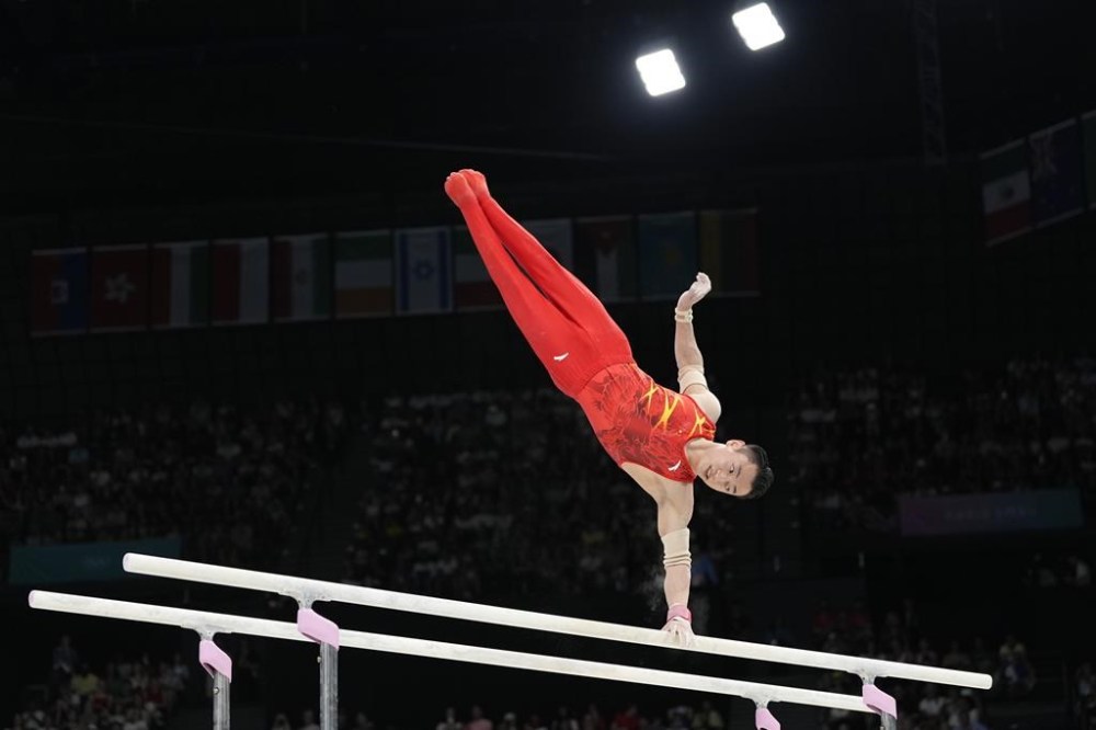 Zou Jingyuan, of China, competes during the men's artistic gymnastics individual parallel bars finals at Bercy Arena at the 2024 Summer Olympics, Monday, Aug. 5, 2024, in Paris, France. (AP Photo/Abbie Parr)