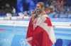 Canada's Summer Mcintosh celebrates winning the gold medal in the women's 200-meter individual medley at the Summer Olympics in Nanterre, France, Saturday, Aug. 3, 2024. (AP Photo/Tsvangirayi Mukwazhi)