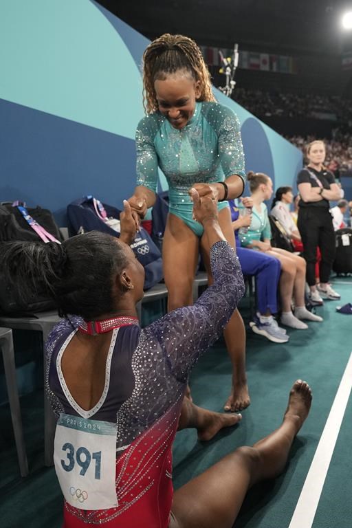 Simone Biles (391), of the United States, greets Rebeca Andrade, of Brazil, after competing during the women's artistic gymnastics individual floor finals at Bercy Arena at the 2024 Summer Olympics, Monday, Aug. 5, 2024, in Paris, France. (AP Photo/Abbie Parr)