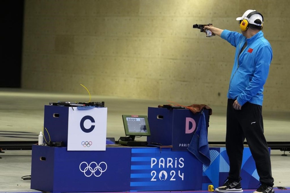 China's Li Yuehong competes in the 25m rapid fire pistol men's final at the 2024 Summer Olympics, Monday, Aug. 5, 2024, in Chateauroux, France. (AP Photo/Manish Swarup)