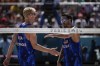 US' Chase Budinger and Miles Evans react during the men's round of 16 beach volleyball match between USA and Norway at Eiffel Tower Stadium at the 2024 Summer Olympics, Monday, Aug. 5, 2024, in Paris, France. (AP Photo/Louise Delmotte)