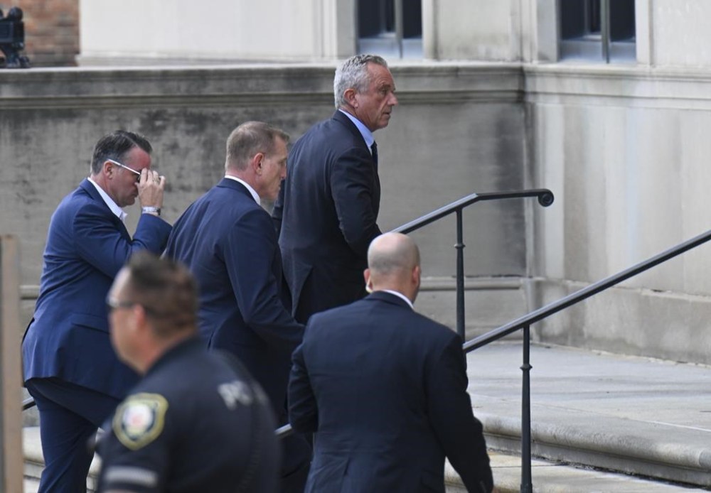 Independent presidential candidate Robert F. Kennedy Jr., top, arrives at the Albany County Courthouse, Monday, Aug. 5, 2024, in Albany, N.Y. Kennedy is fighting a lawsuit claiming he falsely claimed to live in New York as he sought to get on the ballot in the state. (AP Photo/Hans Pennink)