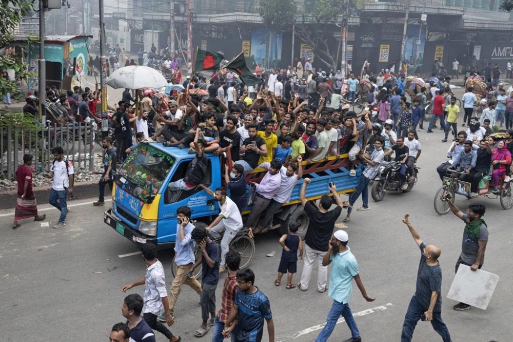 Protesters celebrate after news of Prime Minister Sheikh Hasina's resignation, in Dhaka, Bangladesh, Monday, Aug. 5, 2024. (AP Photo/Fatima Tuj Johora)