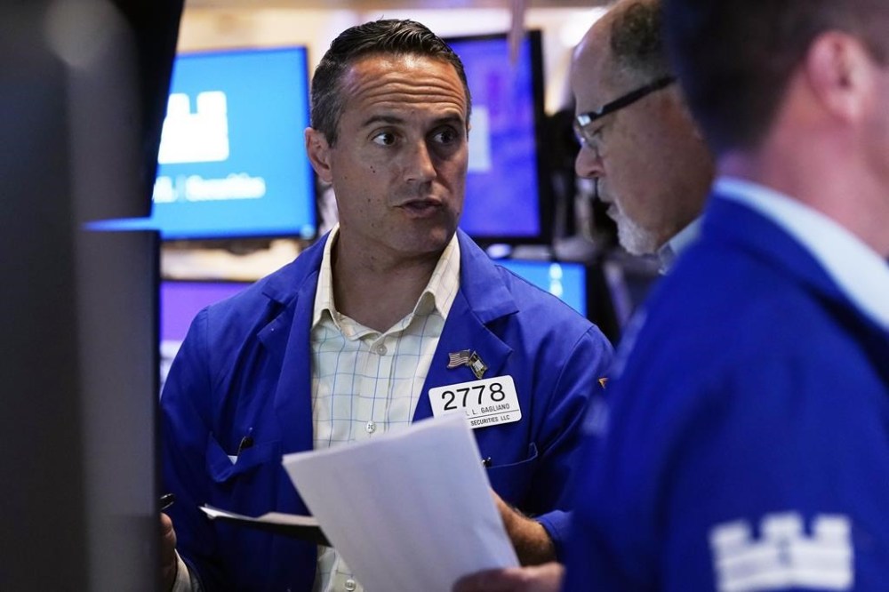 Specialist Michael Gagliano, left, confers with a colleague on the floor of the New York Stock Exchange, Monday, Aug. 5, 2024.(AP Photo/Richard Drew)