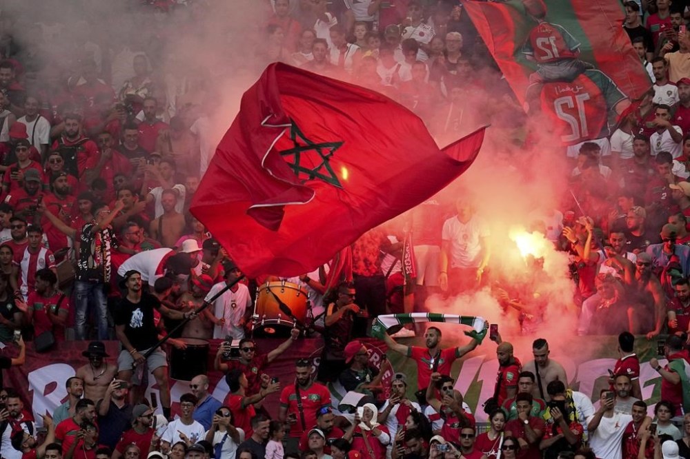 Morocco's fan celebrate as Soufiane Rahimi scoring a penalty goal during a men's semifinal soccer match between Morocco and Spain at the 2024 Summer Olympics, Monday, Aug. 5, 2024, at Marseille Stadium in Marseille, France. (AP Photo/Julio Cortez)