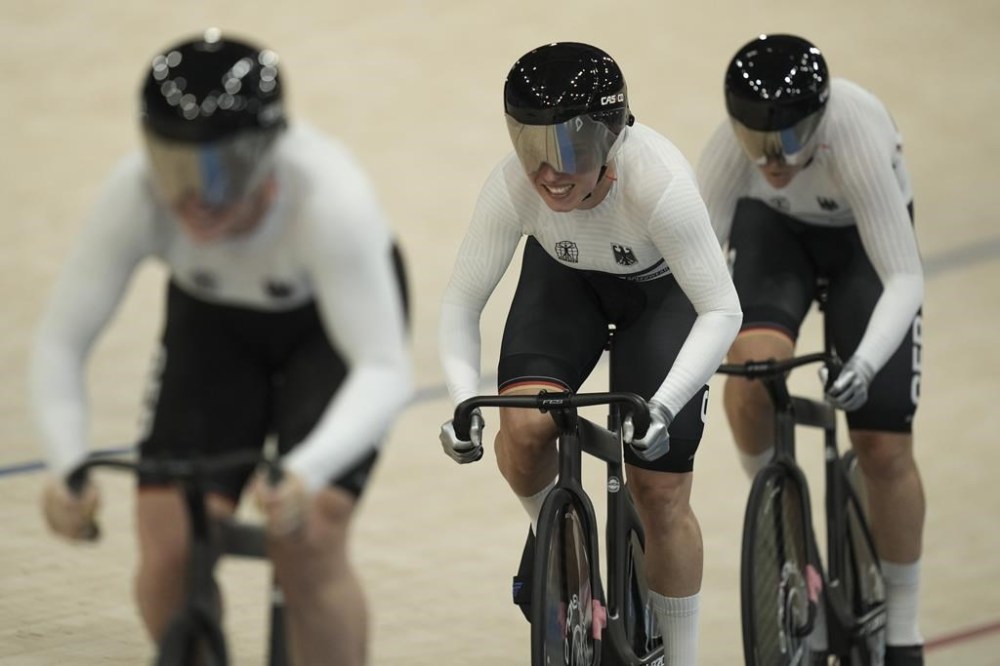 Germany's Pauline Grabosch, Germany's Emma Hinze and Germany's Lea Friedrich compete during the women's team sprint event, at the 2024 Summer Olympics, Monday, Aug. 5, 2024, in Saint-Quentin-en-Yvelines, France. (AP Photo/Thibault Camus)